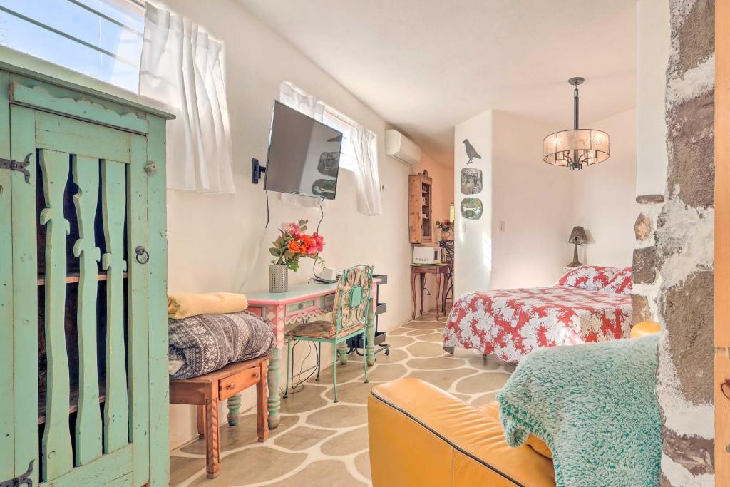 a living room with a green door and a bedroom at Quirky Santa Cruz Studio with Shared Hot Tub! in Santa Cruz