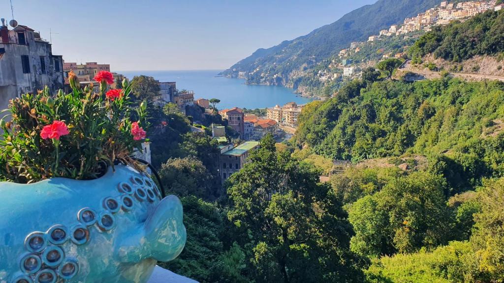 a vase with flowers in it sitting on a ledge at CASA VACANZE DI MARILENA in Vietri sul Mare