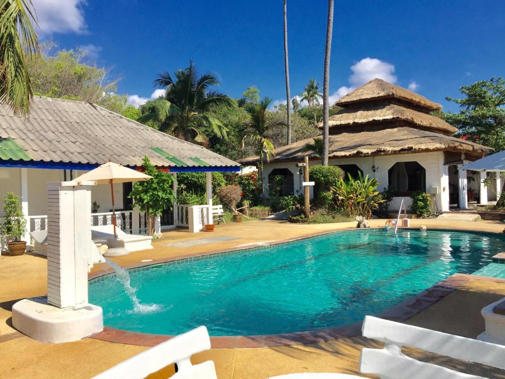 a swimming pool in front of a house at Lamai chalet in Amphoe Koksamui