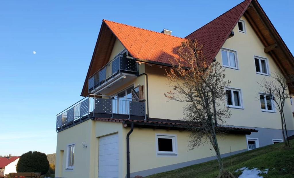 a white house with an orange roof at Ferienhaus Seefried in Baiersbronn