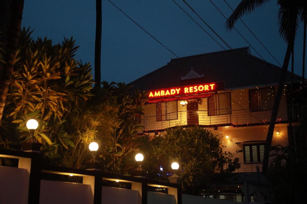 ein Gebäude mit Neonschild in der Nacht in der Unterkunft Athirappilly Ambady Resort in Athirappilly
