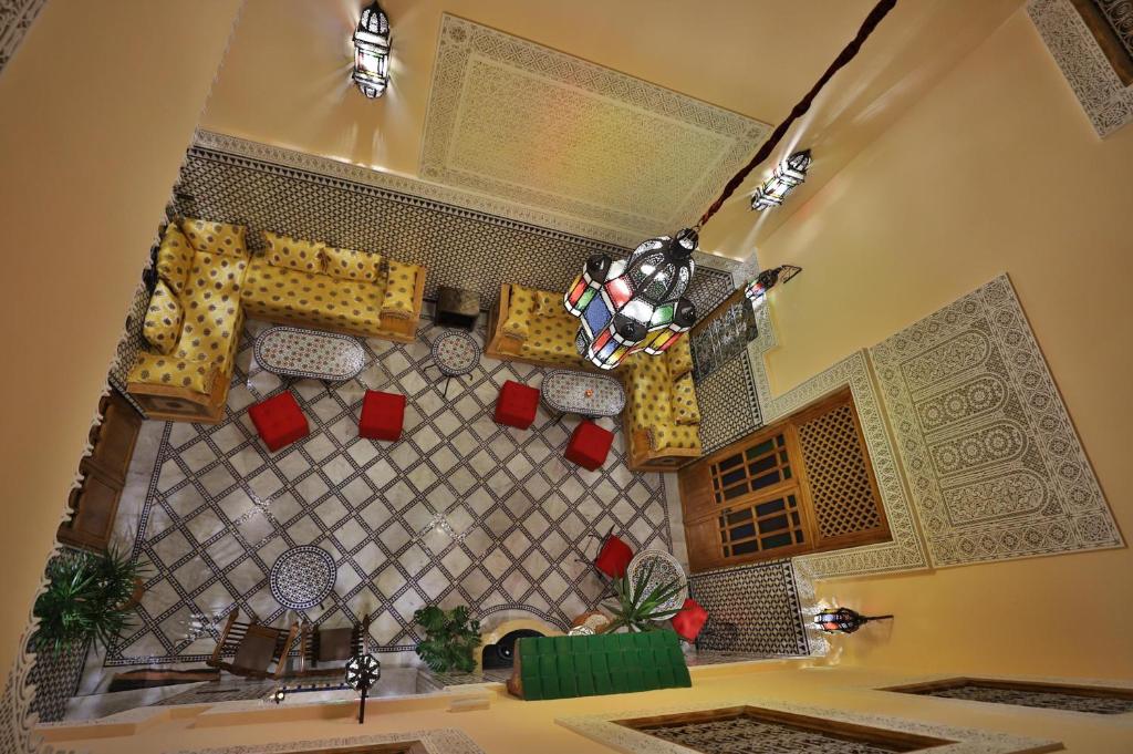 an overhead view of a room with chairs and a table at Riad Diamant De Fes in Fez