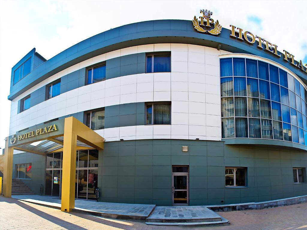 a building with a sign on top of it at Plaza Hotel in Volgograd