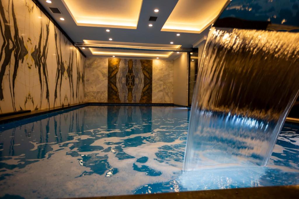 a pool with a water fountain in a room at Hamitbey Hotel Yenikapı in Istanbul