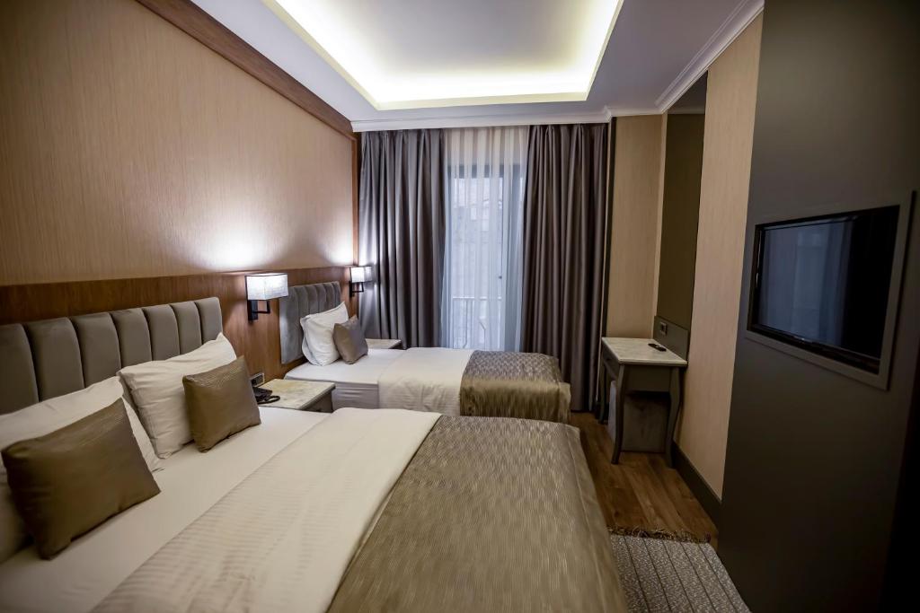 Postel nebo postele na pokoji v ubytování Hamitbey Hotel Yenikapı