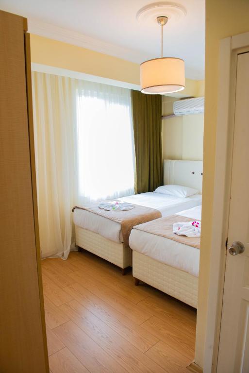 Postel nebo postele na pokoji v ubytování Hotel Simsek