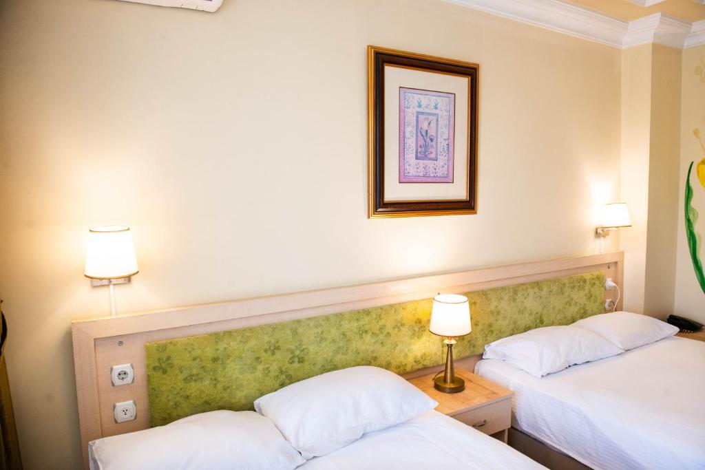 Postel nebo postele na pokoji v ubytování Hotel Simsek