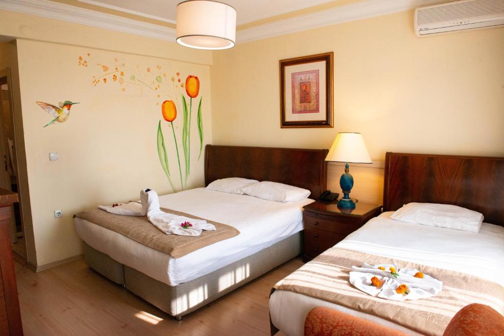 Postel nebo postele na pokoji v ubytování Hotel Simsek