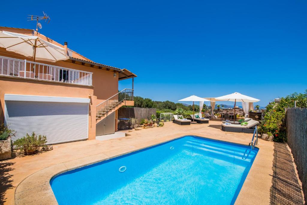 uma villa com uma piscina e uma casa em Ideal Property Mallorca - Els Moyans em Muro