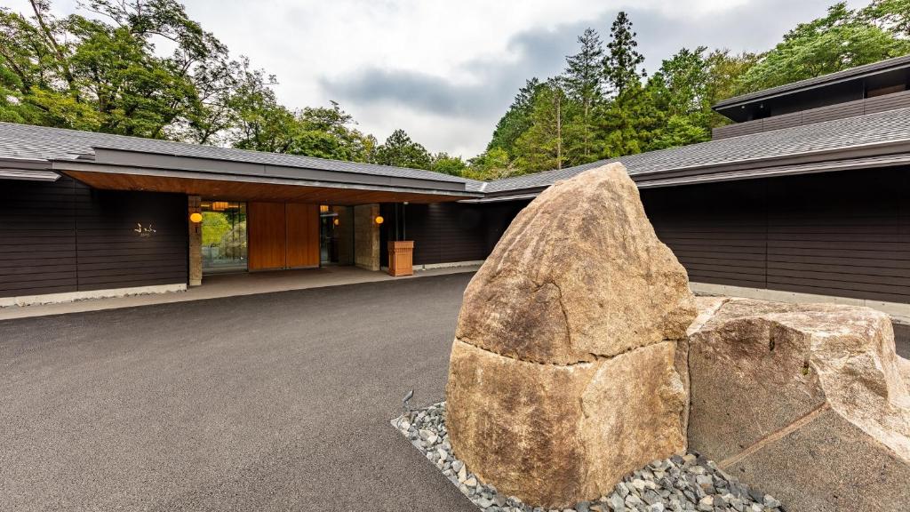 a large rock sits in front of a building at Fufu Nikko in Nikko