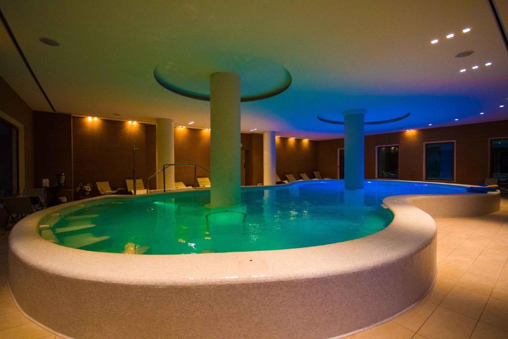 a large swimming pool with a large mirror at Hotel Villa Ricci & Benessere in Chianciano Terme
