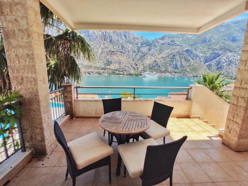 a balcony with a table and chairs and a view of the water at Stunning view to Kotor bay and Old town - C2 Vista in Muo