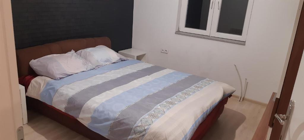 a bed with two pillows on it in a room at Vila city in Bijeljina