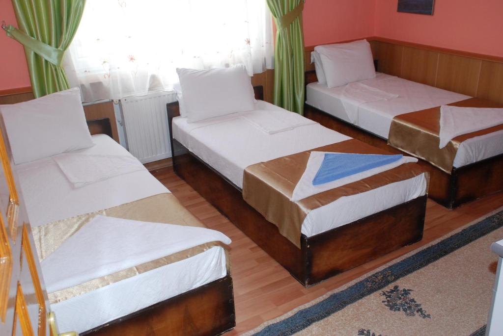 A bed or beds in a room at Aspawa Hotel