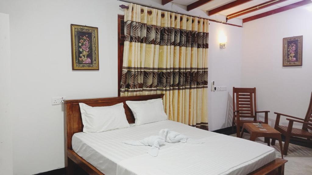 Postel nebo postele na pokoji v ubytování SK HOUSE RESORT UNAWATUNA
