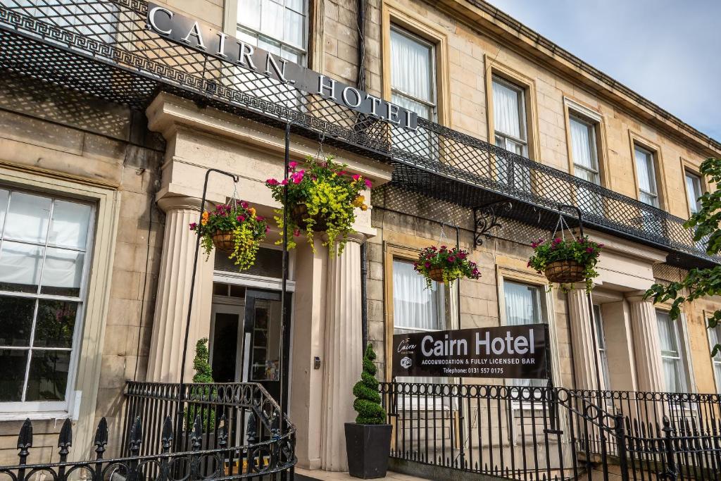 a building with flower pots on the front of it at Cairn Hotel & Apartments in Edinburgh