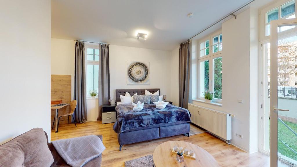 1 dormitorio con 1 cama y 1 mesa en SweetHome - Business-Apartment mit Küche, Terrasse, Stellplatz, en Magdeburgo