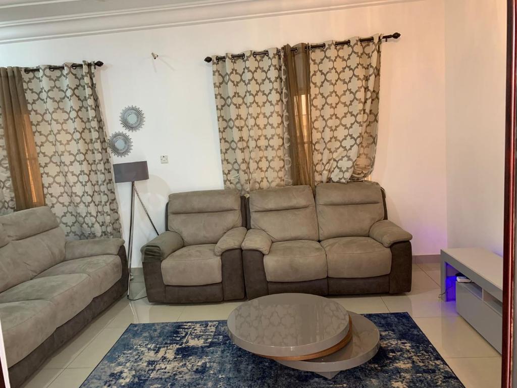 a living room with a couch and a table at Cheerful 3 bedroom bungalow, Fatty Boulevard in Madina Sey Kunda
