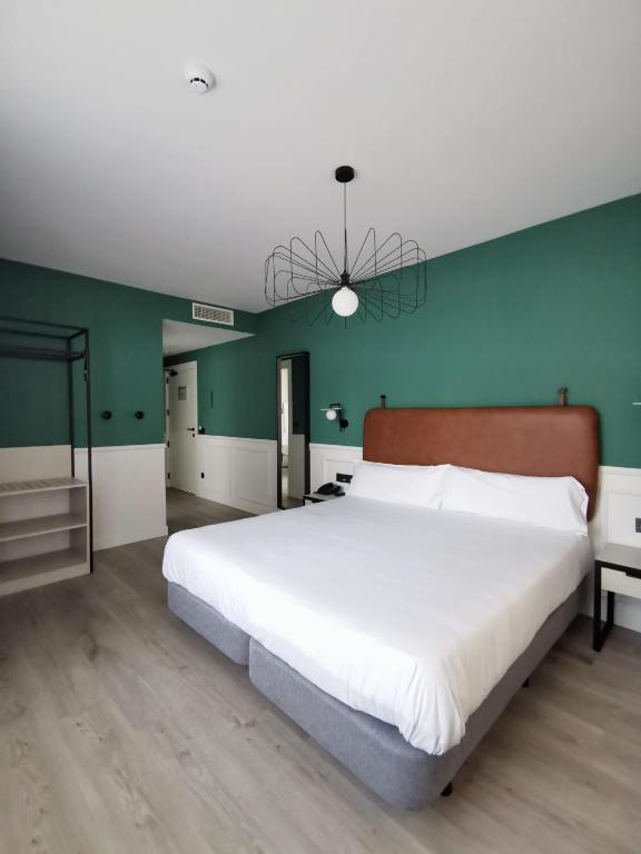 Postel nebo postele na pokoji v ubytování Hotel Don Rodrigo