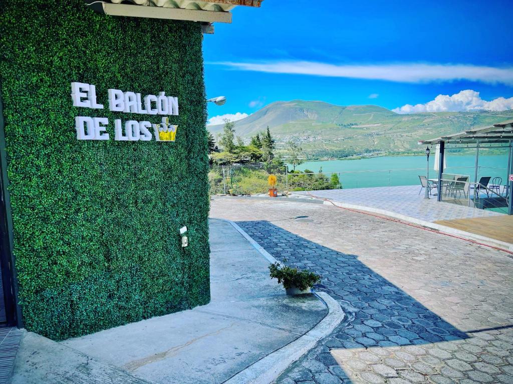 uma parede coberta de hera com um sinal num edifício em El Balcon de los Reyes em Ibarra