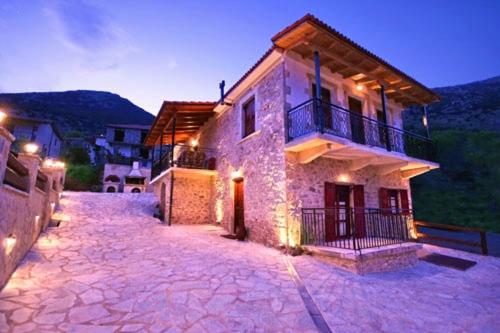 a stone house with a balcony on the side of it at Sponsor of the E4 Peloponnese Trail in Daras