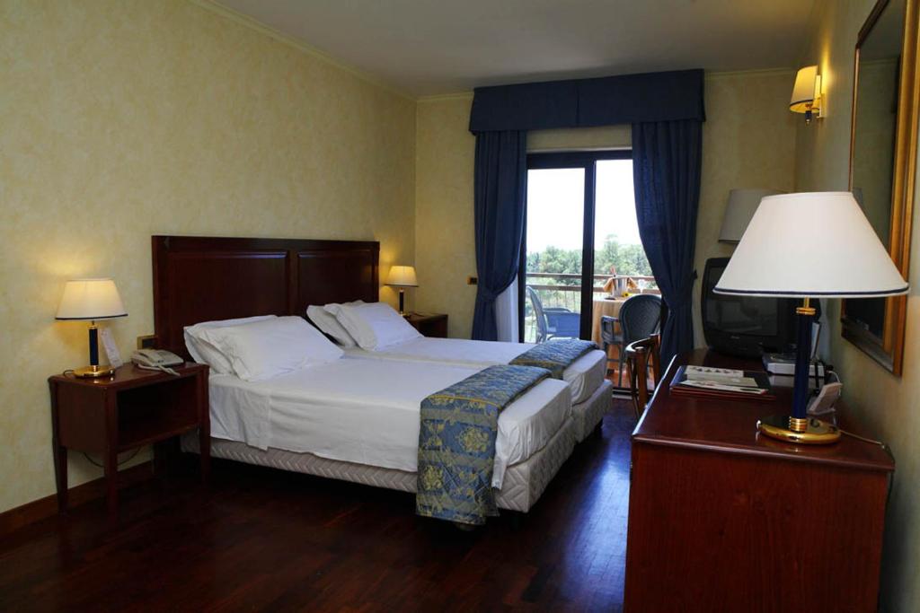 Postel nebo postele na pokoji v ubytování Hotel Della Valle