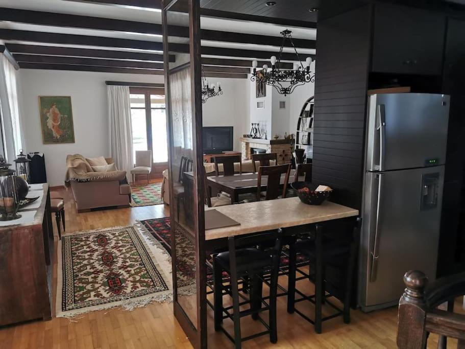 a kitchen and living room with a refrigerator at Ξενώνας Άνθεμις in Levidi