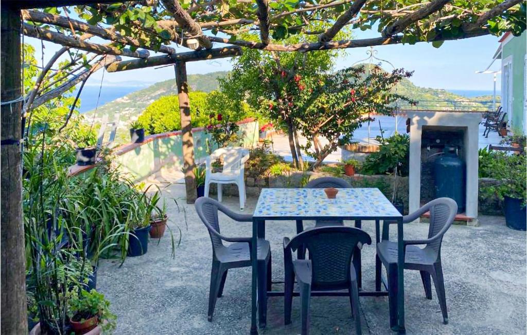 a table and chairs on a patio with a view at 1 Bedroom Lovely Home In Barano Dischia in Ischia