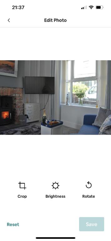 a screenshot of a living room with a fireplace at Cosy seaside cottage in Criccieth
