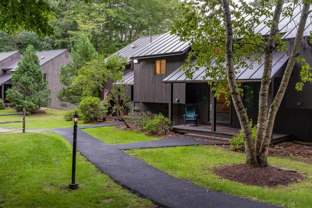 a house with a walkway leading to it at Mill Run 3D in Quechee