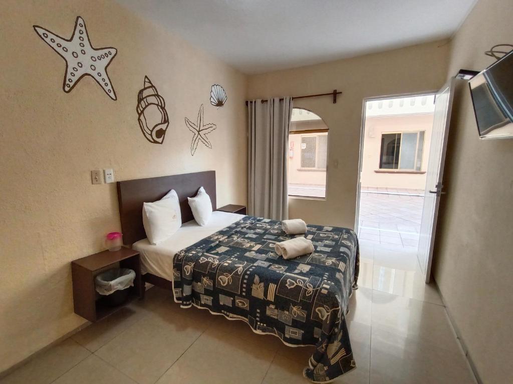 Postel nebo postele na pokoji v ubytování Hotel Playa de Oro - Enfrente de WTC y Plazas Comerciales