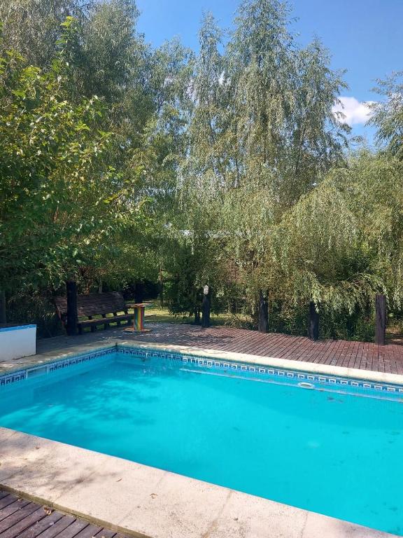 Una gran piscina azul en un patio con árboles en ComplejoGovinda, en Tigre