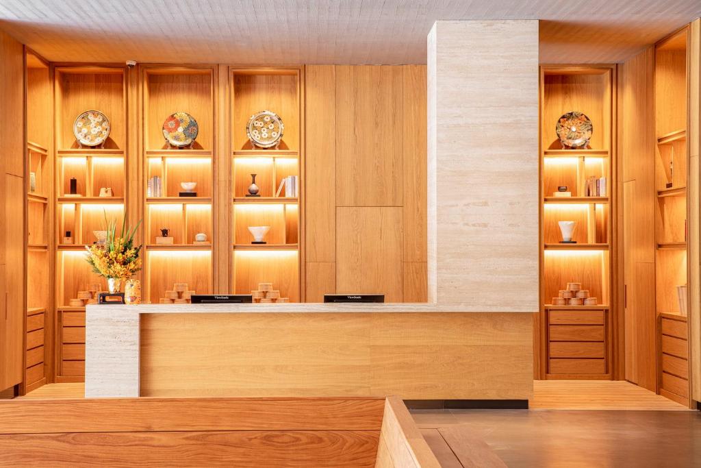 a restaurant with wooden walls and a counter with plates at Wulai Pause Landis Resort in Wulai