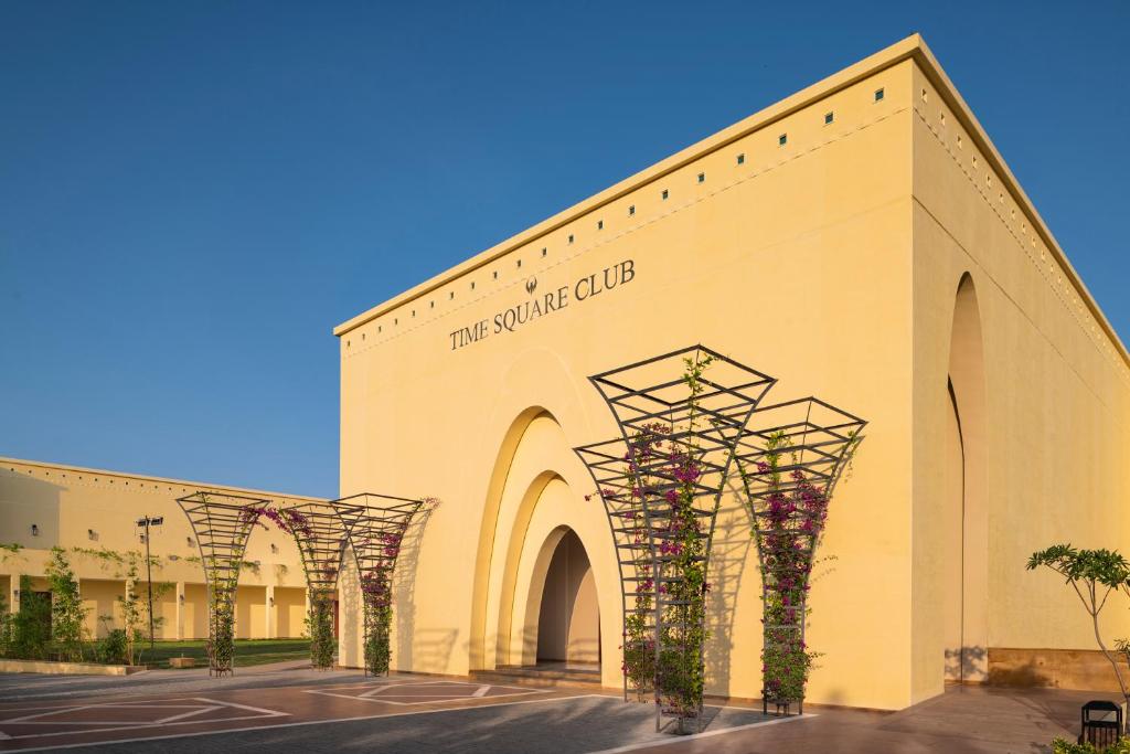 a large building with flowers on the side of it at Time Square Club, Resort & Spa in Bhuj