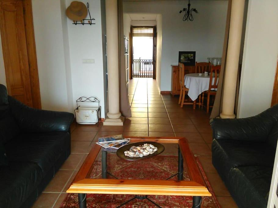 uma sala de estar com um sofá e uma mesa em Acogedora casa de pueblo en Beniarbeig - Alicante Alma em Beniarbeig