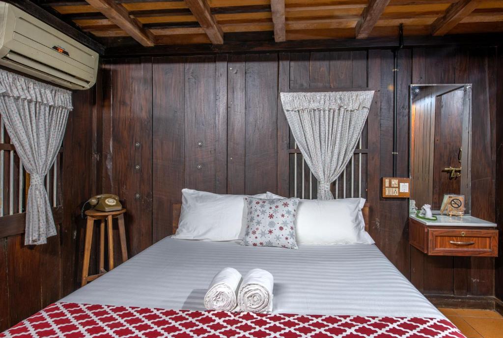 a bedroom with a bed with wooden walls at Swasthi Serviced Villa in Kanjirapalli