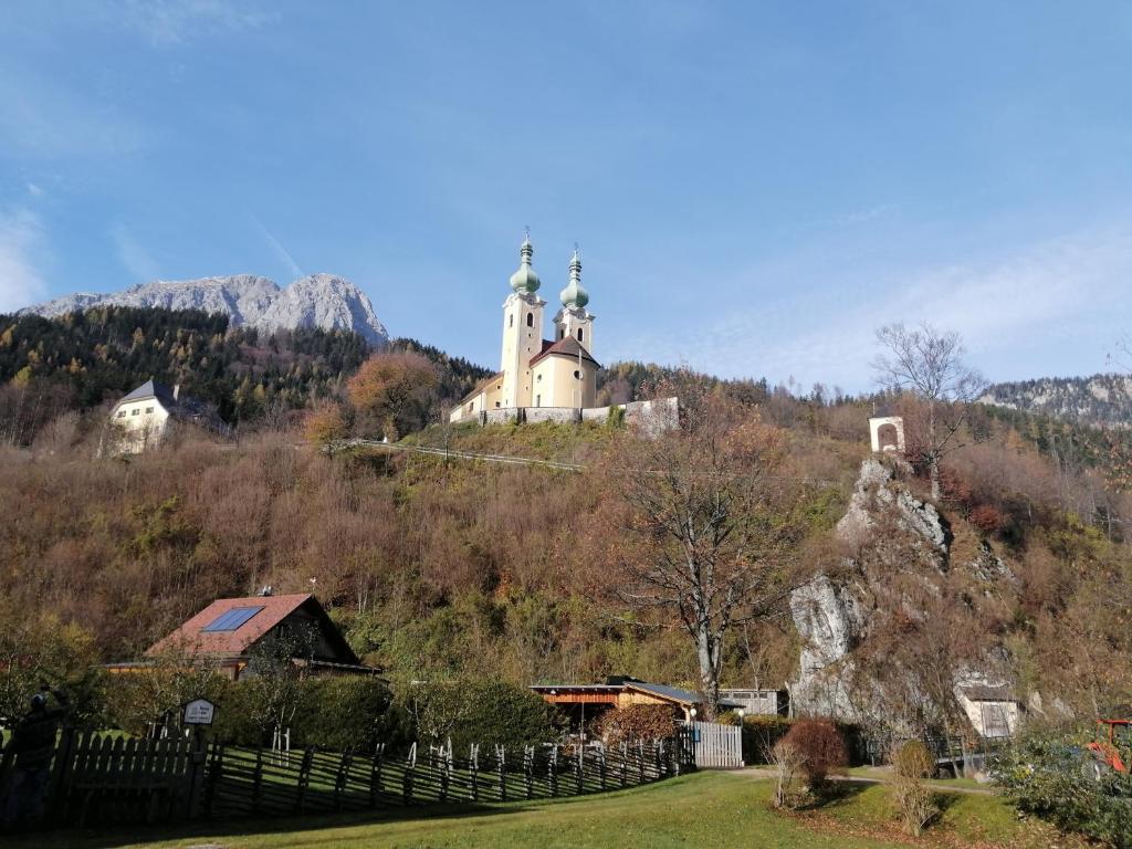 a church on top of a hill with a fence at Ferienwohnung Dallinger in Radmer an der Stube