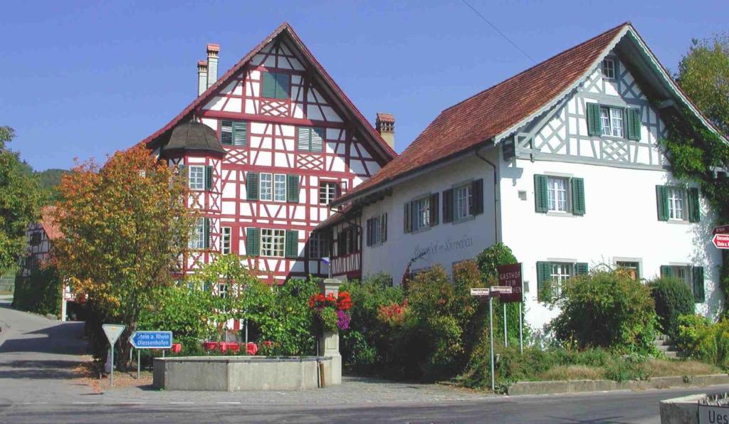 a large white building with a red and white at Hirschen Stammheim in Oberstammheim