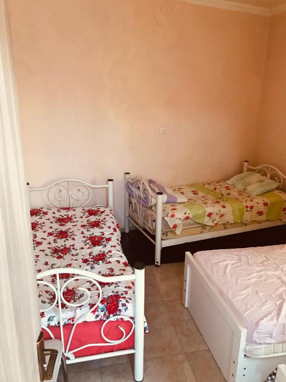 a room with two beds in a room at Sweethome in Batumi