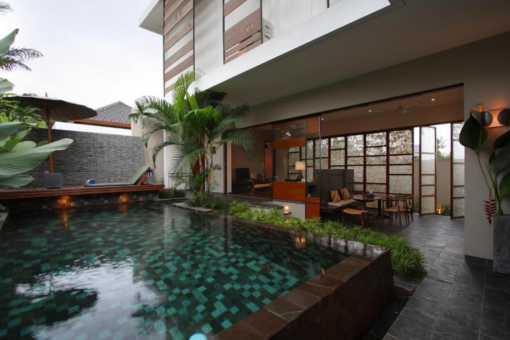 a swimming pool in the middle of a house at Tegal Sari Accommodation Ubud in Ubud