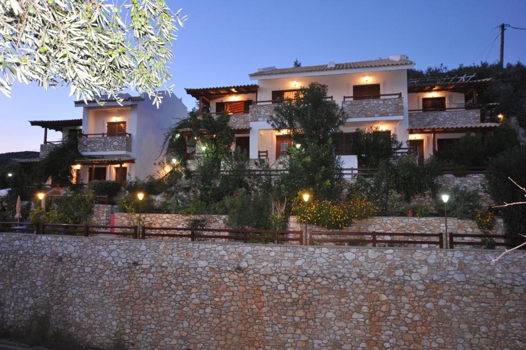 a large white house with lights in front of it at Villa Maraki in Agia Paraskevi