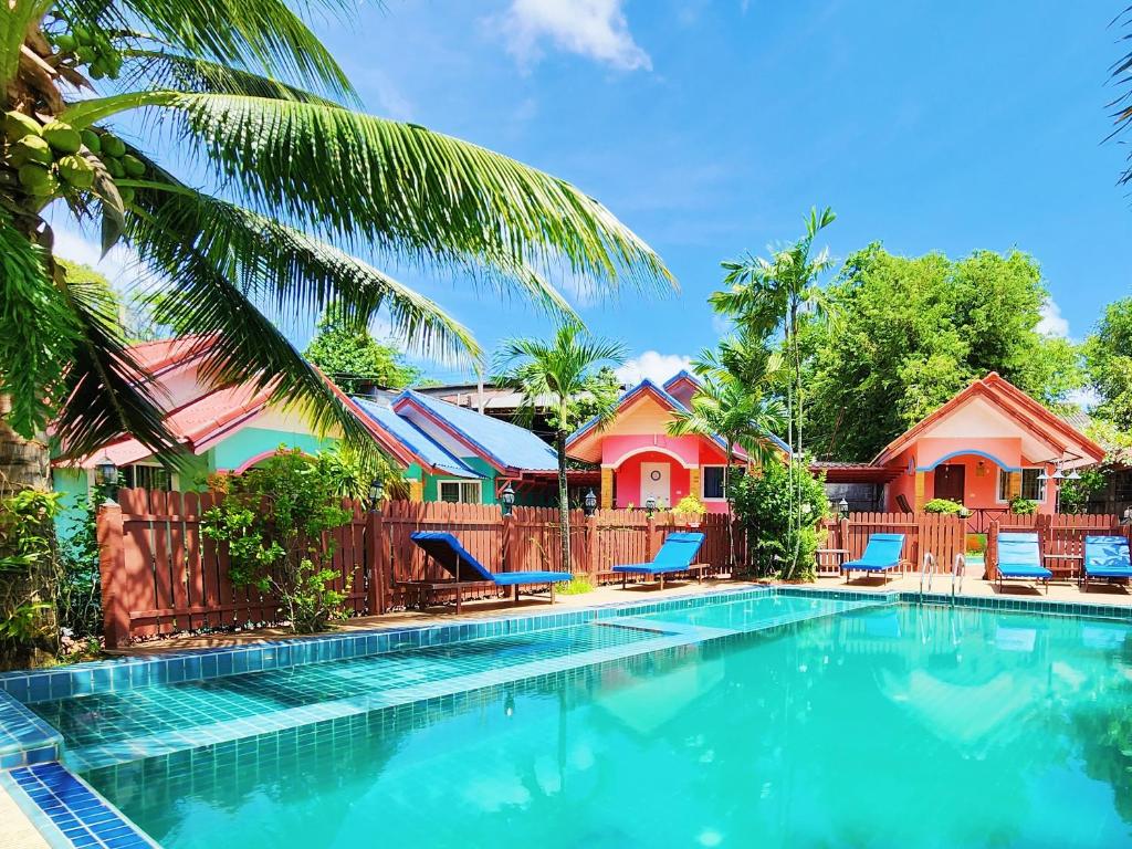 a swimming pool in front of a resort at Phaithong Sotel Resort in Chalong 