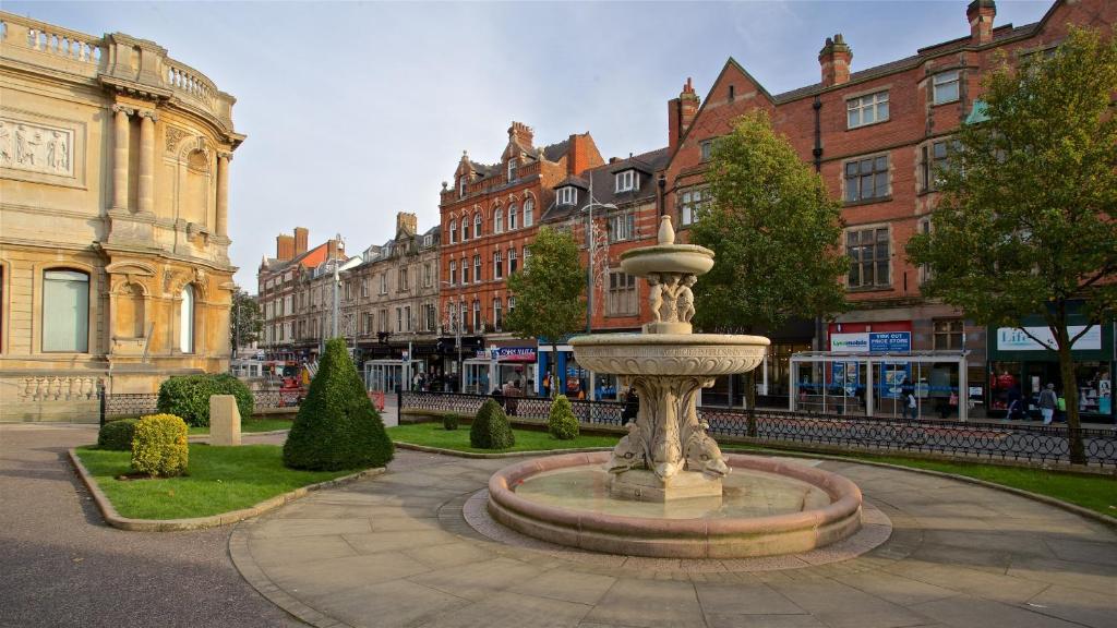 a fountain in the middle of a street with buildings at Luxury 2bed Apartment in Wolverhampton in Wolverhampton