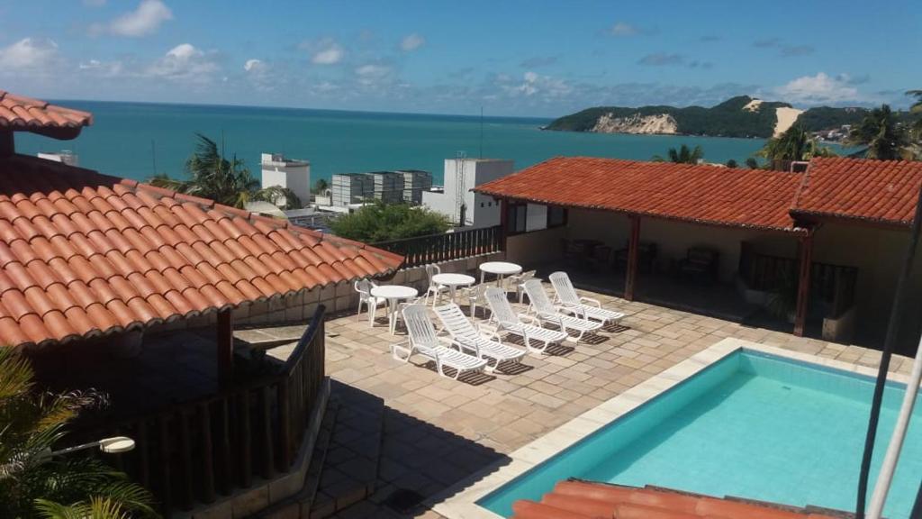 a view of a swimming pool and the ocean at Laina´s Place Hotel in Natal
