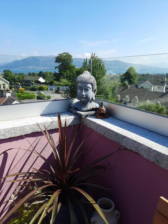 a statue of a head on a ledge at The Quarry House in Carlingford