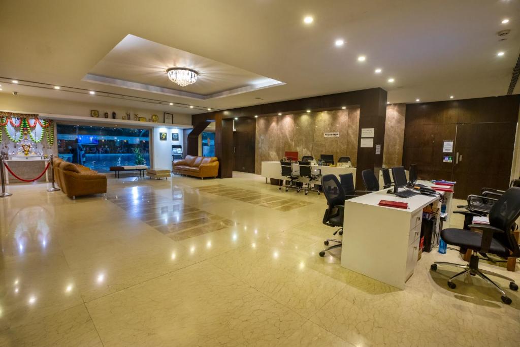 an office with desks and chairs in a lobby at The Thane Club in Thane