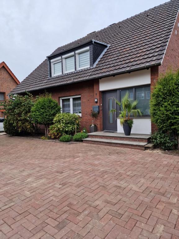 a brick house with a brick driveway at Zimmervermietungen Jachna in Haselünne