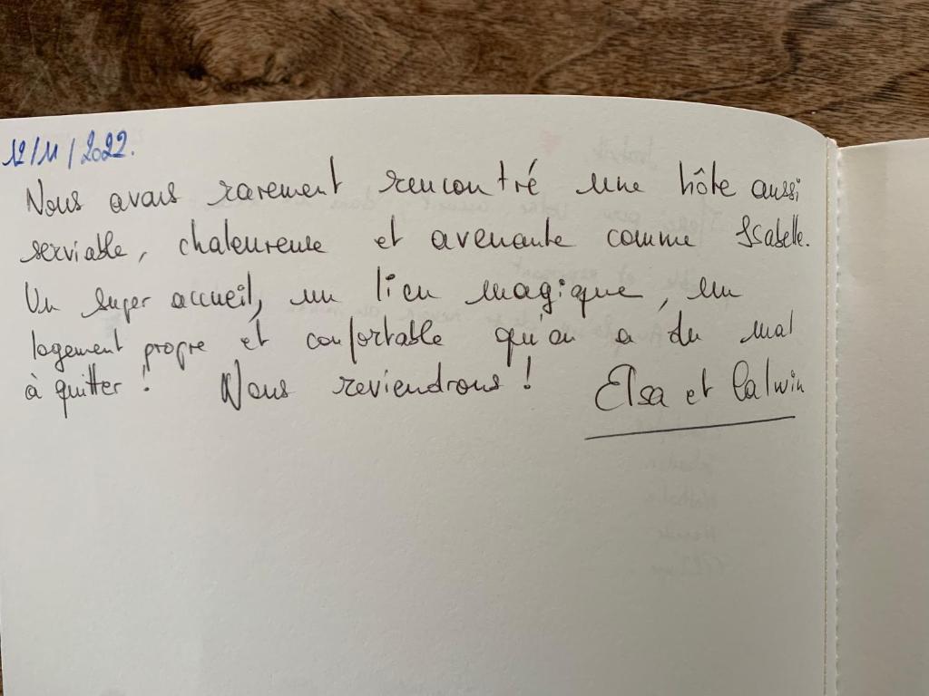 a handwritten note on a white book with handwriting at La coccinelle in Noyarey