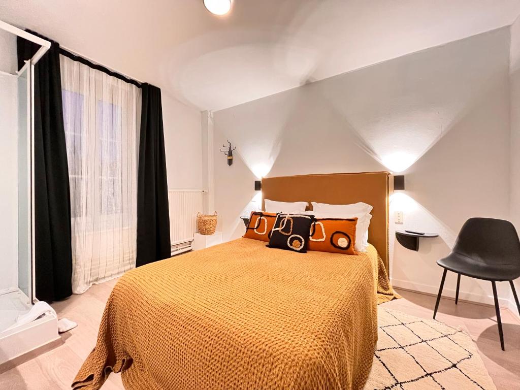 a bedroom with a bed with a camera on it at Hôtel du Commerce in Cluny