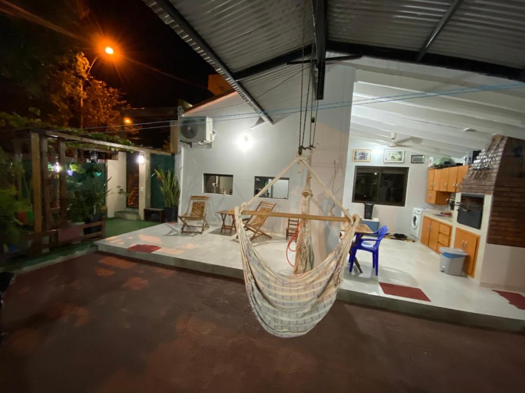 a hammock hanging in a room with a kitchen at POSADA DON CANDIDO in San Antonio